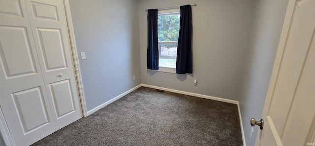 unfurnished bedroom featuring dark colored carpet