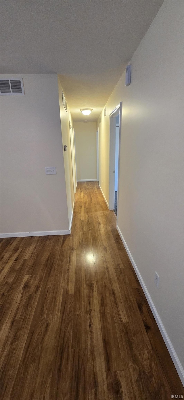 hall with hardwood / wood-style floors