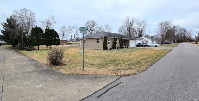 view of side of home with a garage and a lawn