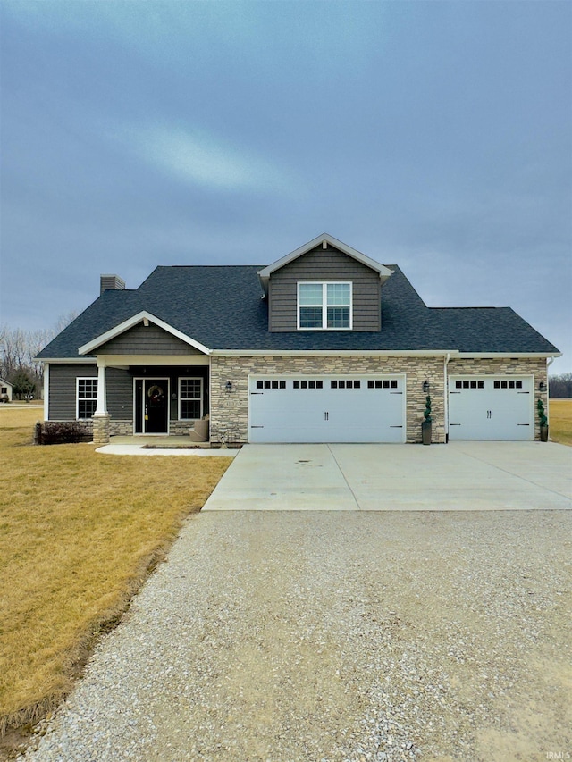 craftsman-style house with a garage, a front yard, and covered porch