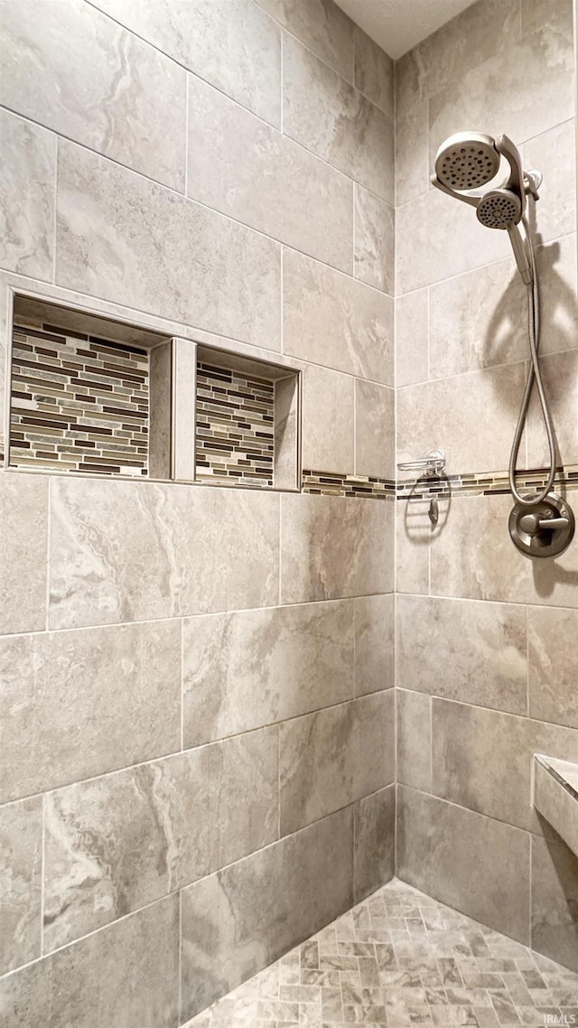 bathroom featuring tiled shower