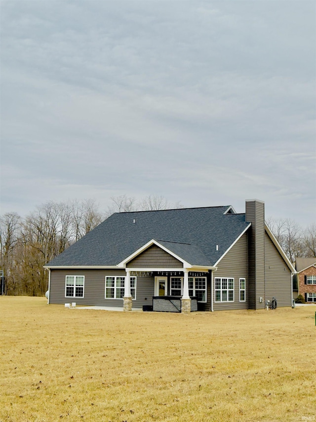 back of property featuring a lawn