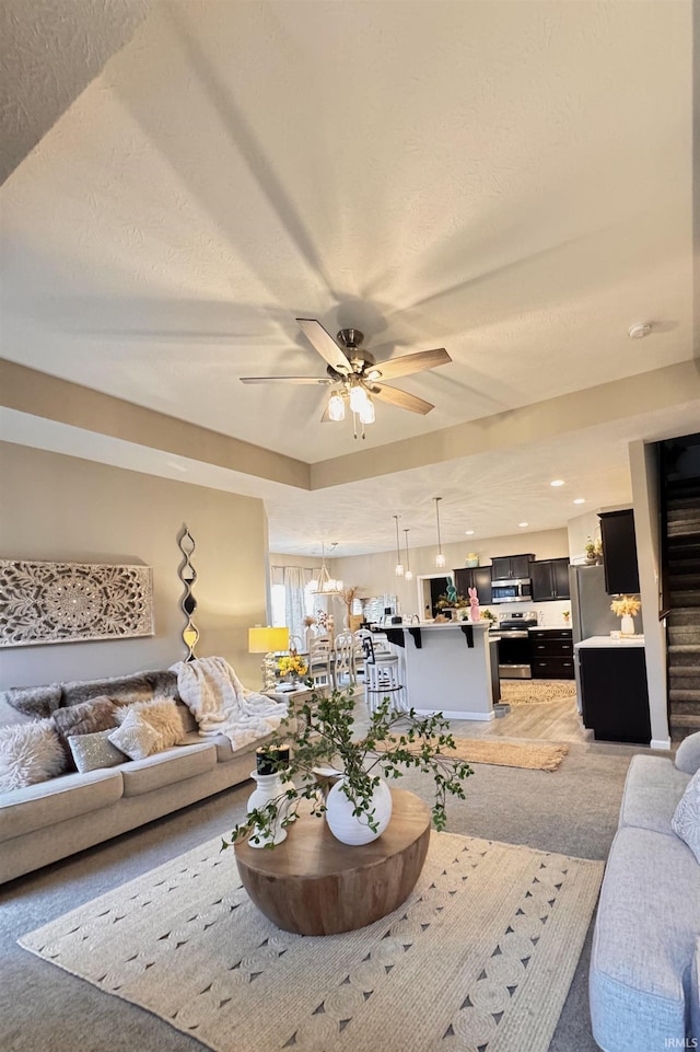 carpeted living room featuring ceiling fan