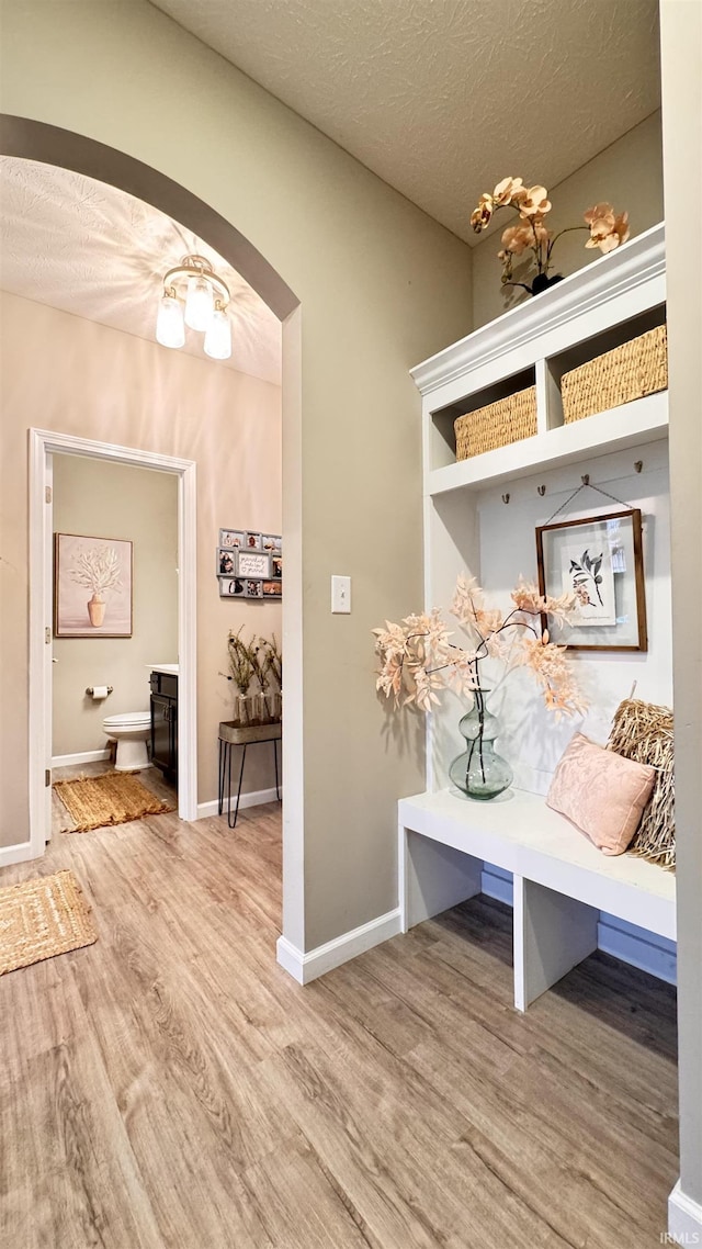 mudroom with hardwood / wood-style floors and a textured ceiling