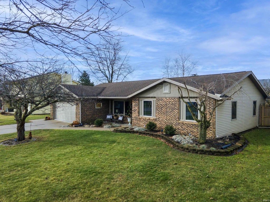 ranch-style home featuring a garage and a front lawn