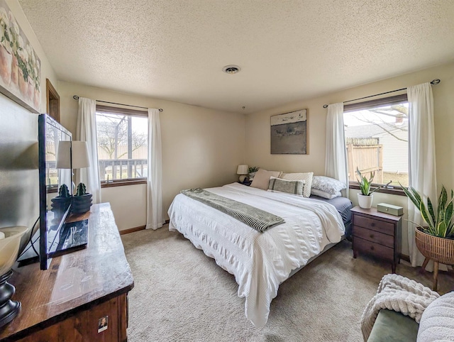 bedroom with carpet and a textured ceiling