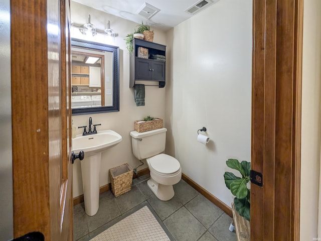 bathroom with sink, tile patterned floors, and toilet