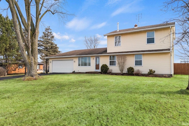 view of front of property with a garage and a front lawn