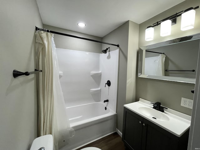 full bathroom featuring hardwood / wood-style flooring, vanity, toilet, and shower / bath combo with shower curtain