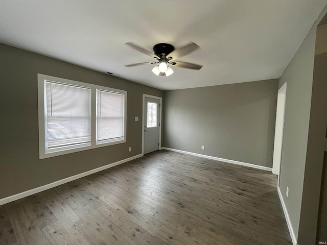 spare room featuring dark hardwood / wood-style floors and ceiling fan