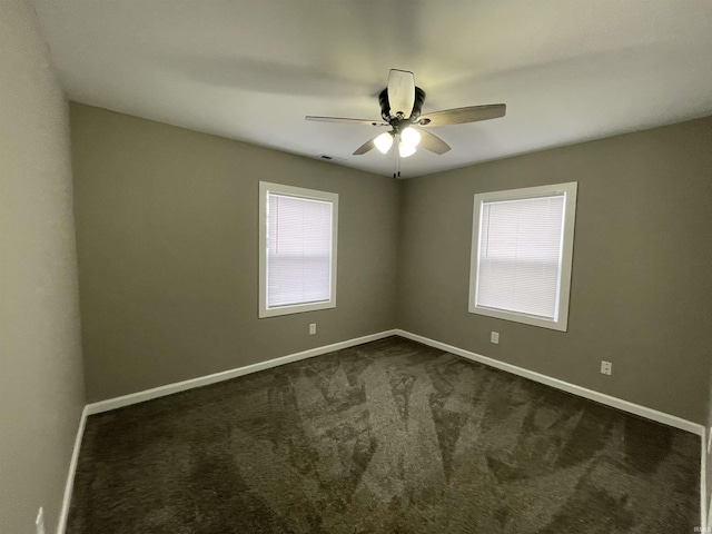 carpeted empty room with ceiling fan and a healthy amount of sunlight