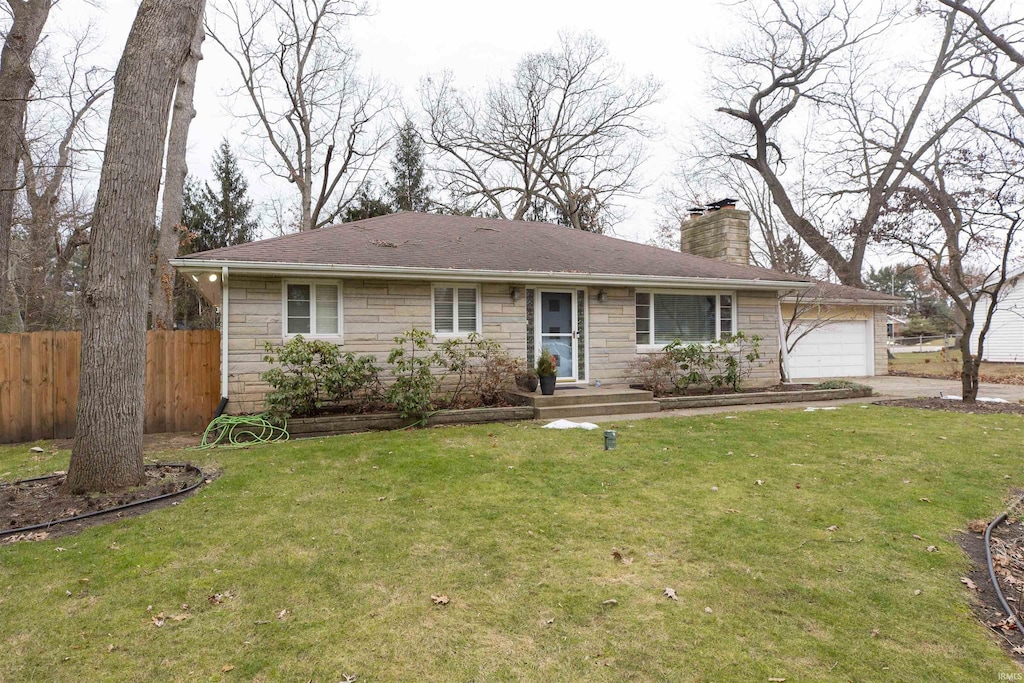 single story home with a garage and a front lawn