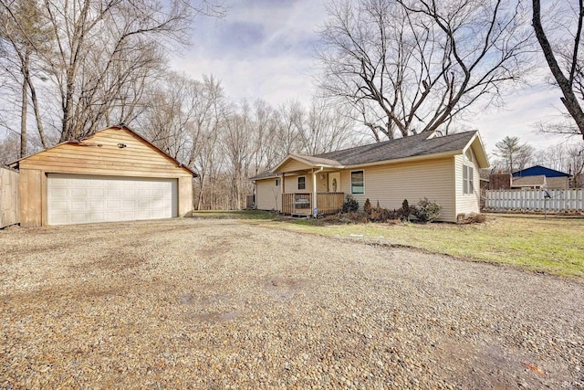 view of front of house featuring a garage and an outbuilding