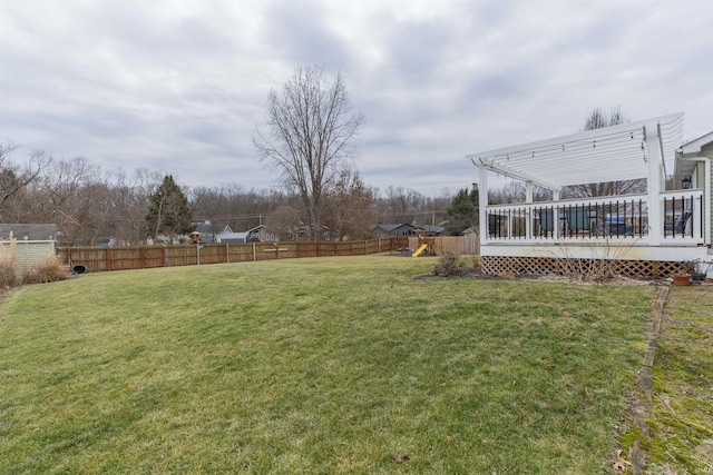 view of yard featuring a wooden deck and a playground