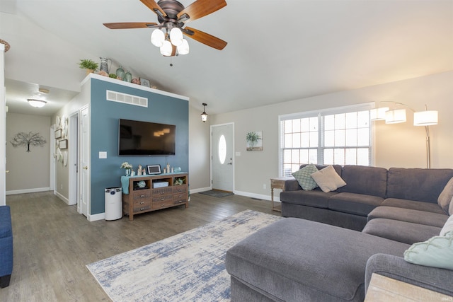 living room with ceiling fan, lofted ceiling, and wood-type flooring