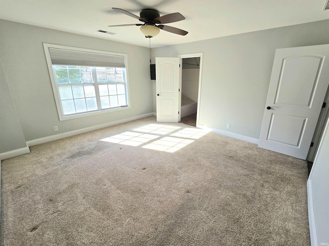 unfurnished bedroom featuring light carpet and ceiling fan