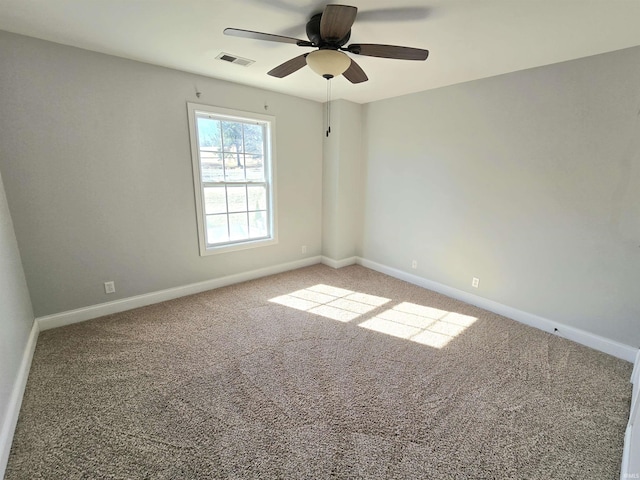 carpeted empty room featuring ceiling fan