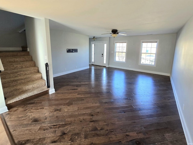 interior space with dark wood-type flooring and ceiling fan