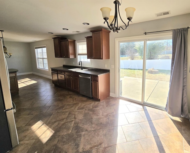 kitchen featuring hanging light fixtures, sink, stainless steel dishwasher, and a notable chandelier