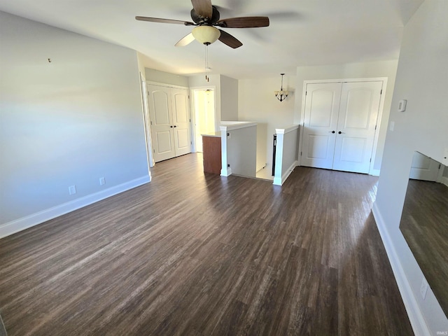 empty room with dark hardwood / wood-style floors and ceiling fan