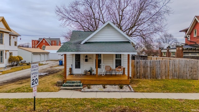 bungalow-style house featuring a front yard and covered porch