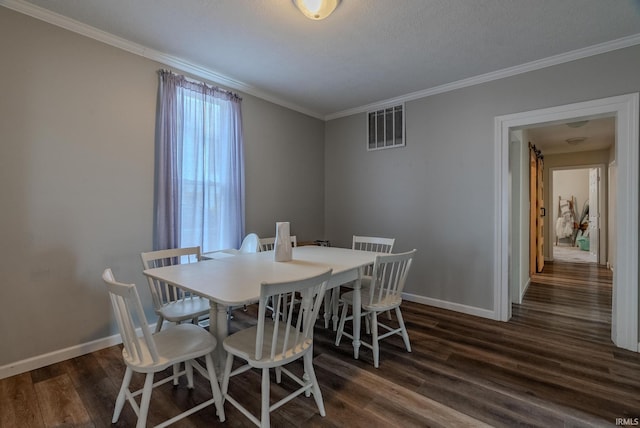 dining area featuring dark wood-type flooring and ornamental molding