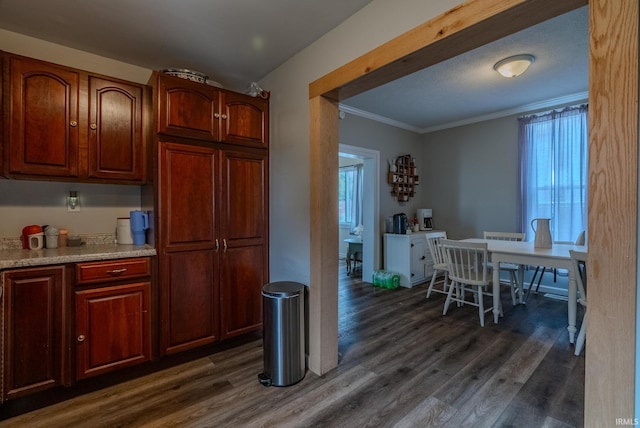 kitchen featuring crown molding and dark hardwood / wood-style floors