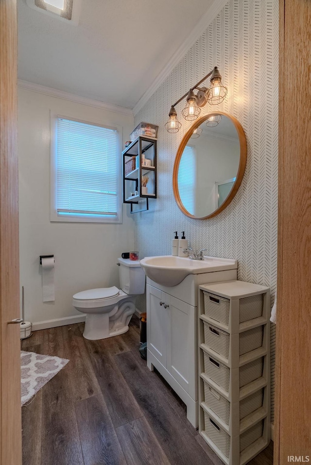 bathroom with ornamental molding, hardwood / wood-style floors, vanity, and toilet