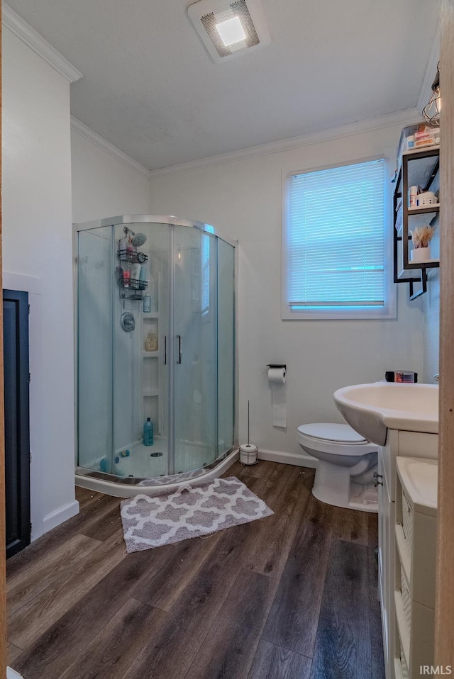 bathroom with ornamental molding, vanity, toilet, and hardwood / wood-style floors