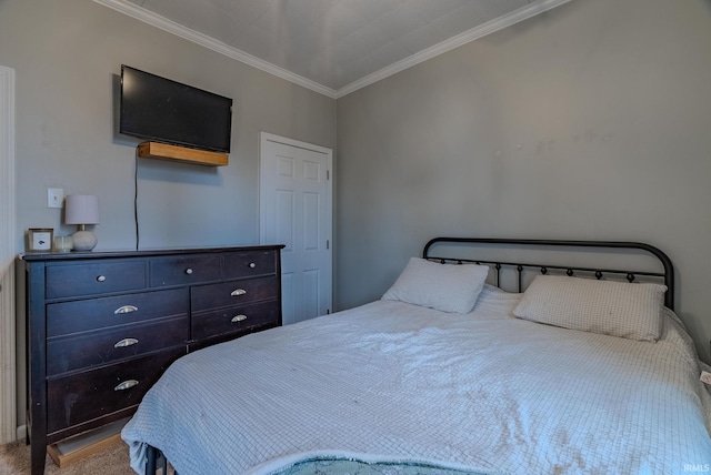 bedroom with crown molding and carpet floors