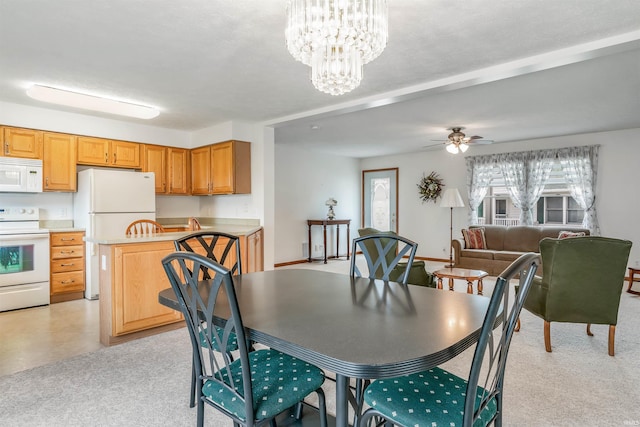 dining area with ceiling fan with notable chandelier and light carpet