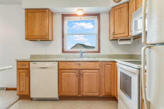 kitchen featuring white appliances and sink