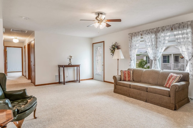 carpeted living room featuring ceiling fan