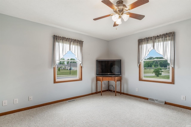 unfurnished living room with carpet and ceiling fan