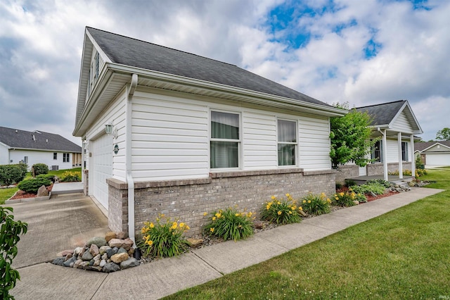 view of home's exterior featuring a yard and a garage