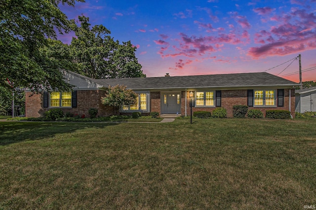 single story home with a lawn