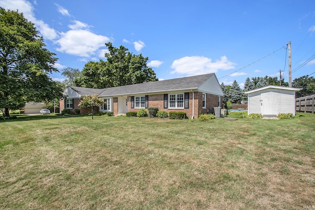 view of front facade featuring a storage shed and a front lawn