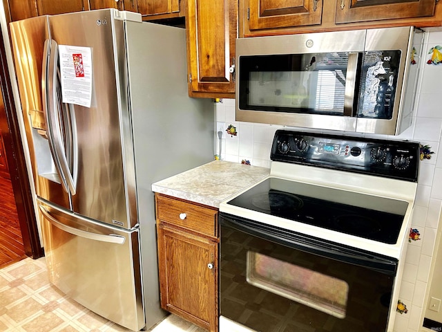 kitchen with tasteful backsplash and stainless steel appliances