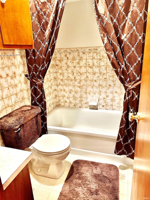 bathroom with tile patterned floors, toilet, vanity, and tile walls