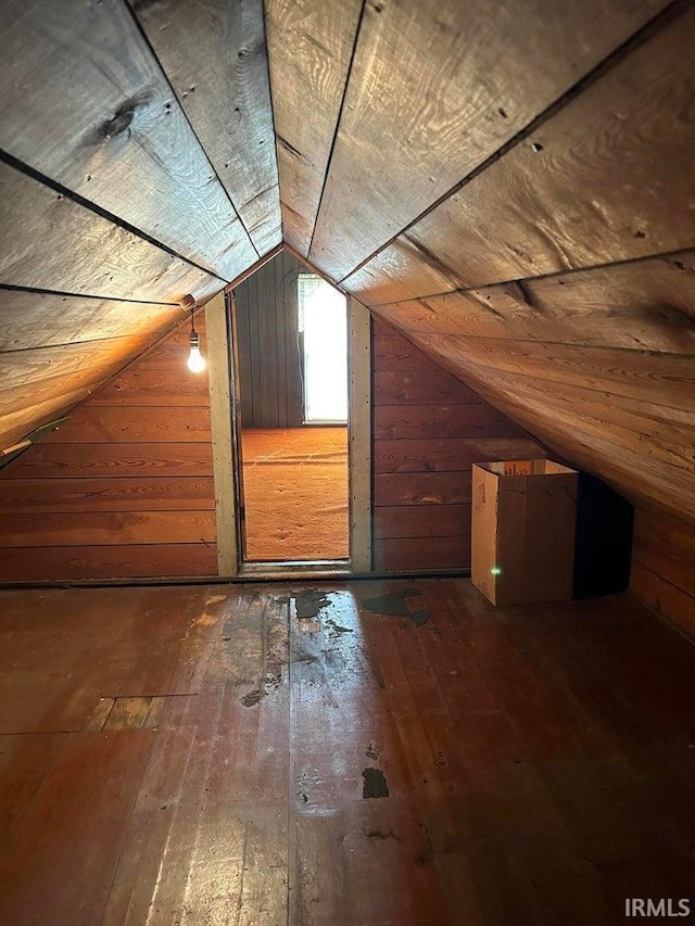 bonus room with wood ceiling, hardwood / wood-style flooring, vaulted ceiling, and wood walls