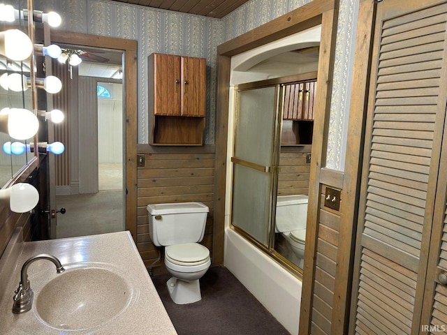 full bathroom featuring vanity, toilet, and combined bath / shower with glass door