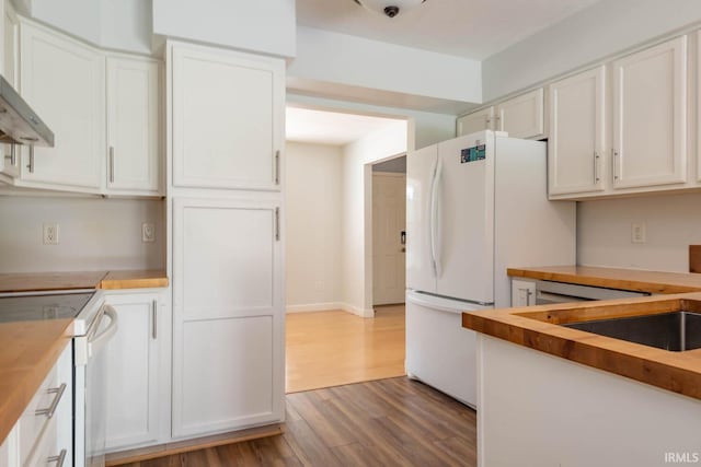 kitchen featuring dark wood-type flooring, sink, butcher block countertops, white cabinets, and white range with electric stovetop