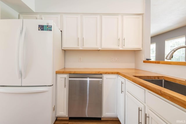 kitchen with wood counters, sink, white refrigerator, dishwasher, and white cabinets