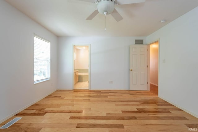 unfurnished bedroom with ensuite bathroom, ceiling fan, and light wood-type flooring