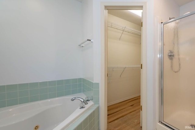 bathroom with plus walk in shower and wood-type flooring