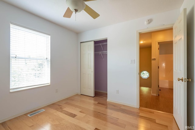 unfurnished bedroom with a closet, ceiling fan, and light wood-type flooring