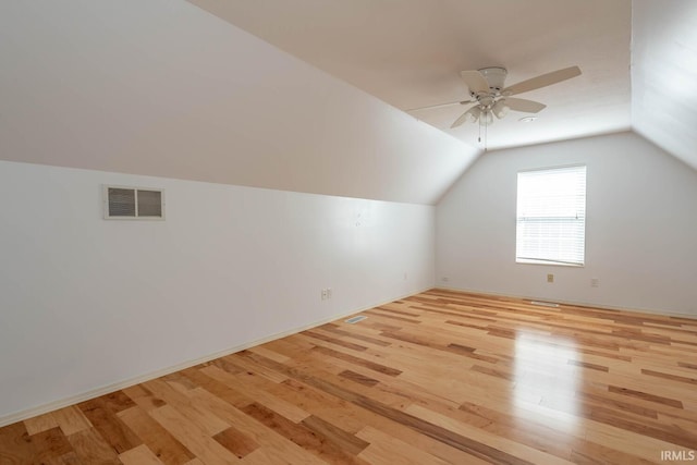 additional living space featuring vaulted ceiling, ceiling fan, and light wood-type flooring