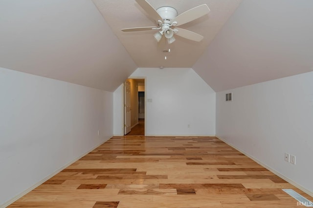 additional living space featuring vaulted ceiling, ceiling fan, and light wood-type flooring