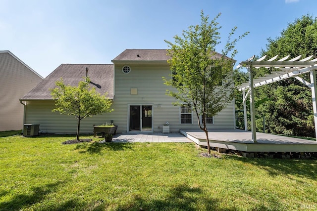 rear view of property with a deck, a lawn, central AC unit, and a pergola