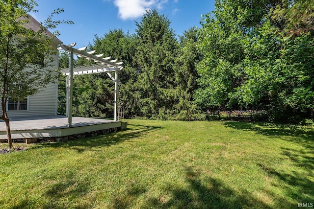 view of yard featuring a wooden deck and a pergola